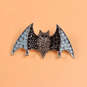 Macro view of a creative bat brooch featuring elegant black and light blue rhinestones