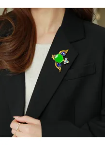 Elegant bird brooch with vibrant green jelly stone on a black professional blazer lapel