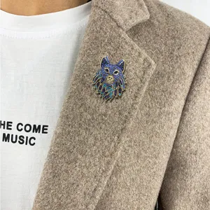 Stunning vintage wolf head brooch with blue rhinestones on a brown tweed blazer