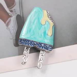 Close-up of creative enamel popsicle brooch with blue marble texture and rhinestones.