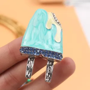 Detailed view of a cute blue enamel popsicle brooch decorated with blue rhinestones