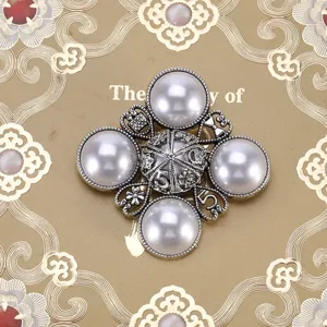 Vintage Baroque silver brooch featuring four large pearls and ornate number five design