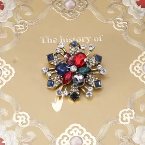 Vintage baroque style snowflake brooch featuring multi-color rhinestones on gold base