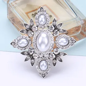 Elegant vintage Baroque style brooch featuring white pearls and sparkling crystals