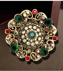 Detailed view of Baroque palace style brooch with colorful crystals and gold filigree