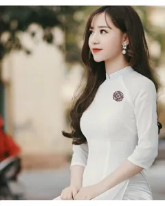 Elegant close-up view of a baroque vintage brooch with red stones on a white dress