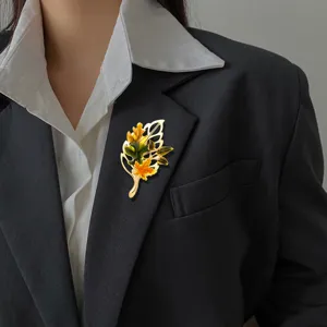 Elegant vintage maple leaf brooch with enamel details on a professional black blazer lapel