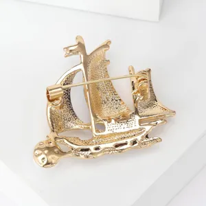 Detailed back view of gold alloy sailboat brooch with secure safety pin clasp