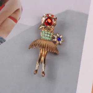 Close-up of vintage gold-plated girl brooch with colorful rhinestone embellishments