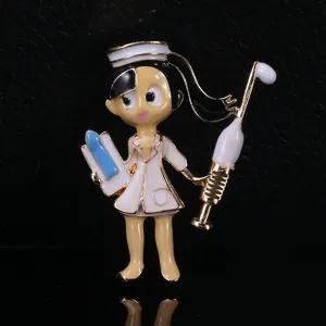 Detailed macro view of a cartoon nurse brooch featuring vibrant enamel and gold plating.