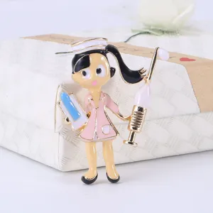Close-up of a cute cartoon nurse enamel brooch pin in pink and gold tones