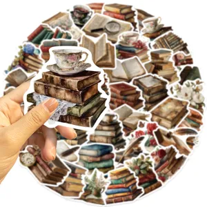 Vintage scrapbooking sticker featuring a stack of old books with a floral teacup on top