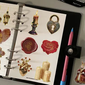 Detailed view of vintage European style gold-stamped stickers applied to a paper binder