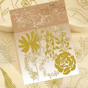 Close-up of gold-foiled botanical PET stickers showing elegant floral line art details.