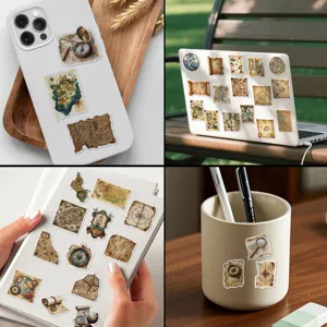 Detail shot of vintage map stickers applied to a phone case, laptop, and notebook.