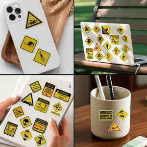 Variedad de divertidas pegatinas de advertencia amarillas en móvil, portátil y cuaderno.