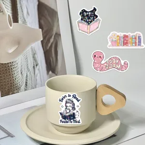 Detail view of bookish themed stickers with star film applied to a beige ceramic cup