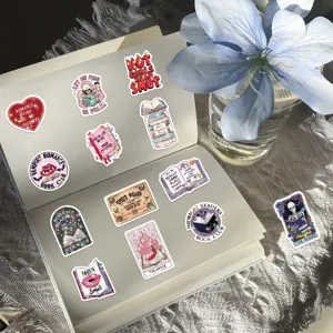 Detailed view of bookish aesthetic stickers with glitter film on an open notebook