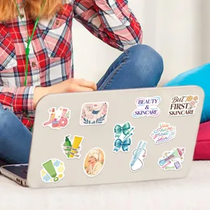 Detailed view of aesthetic skincare and beauty stickers applied on a silver laptop back