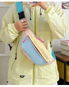 Close-up of a cute pastel color-block nylon crossbody chest bag worn by a model.