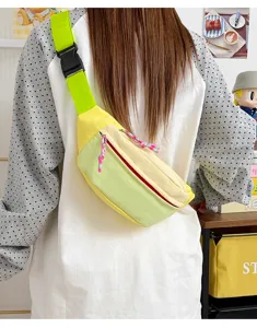 Detailed view of a lightweight color-blocked crossbody chest bag worn on a model's back