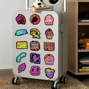 Neon motivational quote stickers for DIY decoration on a white hard-shell suitcase