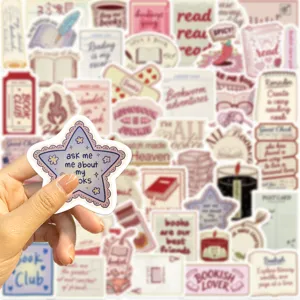 Close-up of hand holding a star-shaped bookish sticker with an assorted background