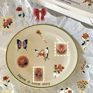 Detailed view of vintage rose and butterfly gold-stamped PET stickers for journaling