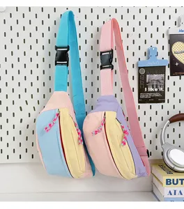 Pastel color-blocked sports chest bag hanging on a minimalist pegboard display