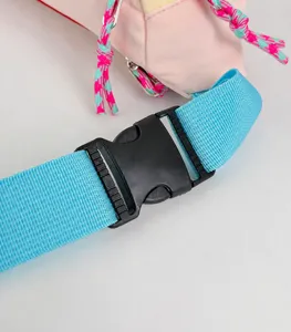 Close-up detail of the durable blue strap and black buckle on pink crossbody chest bag