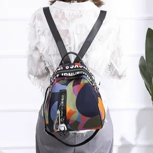 Back view of a colorful Oxford cloth shell backpack with abstract circle patterns and bear charm