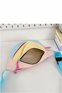 Close-up interior view of open cute pastel pink yellow and blue student chest bag