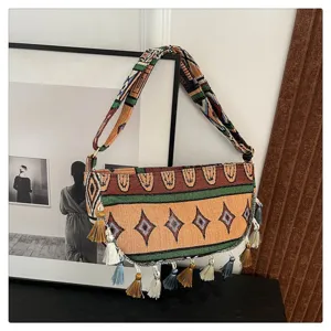 Boho etnische schoudertas met kleurrijke kwastjes en borduursels met retro geometrisch patroon