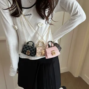 Close-up of four miniature crossbody bags in various colors with metallic chains