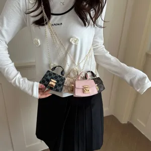 Detailed view of four luxury mini crossbody bags with gold chain straps and M monograms
