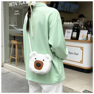 Cute white plush bear crossbody bag worn by a model in front of a cafe close-up