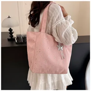 Elegant pink large capacity tote bag featuring silver star patterns worn on shoulder