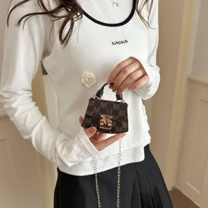 Detailed view of luxury mini crossbody bag with M monogram pattern and gold chain