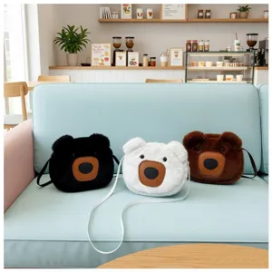Close-up of cute plush bear-shaped crossbody bags in black white and brown colors