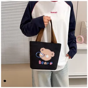 Bolso tote sencillo de lona negra con lindo estampado de oso y asas marrones para uso diario.