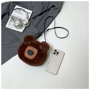 Detailed view of the cute brown plush bear crossbody bag with lifestyle accessories.