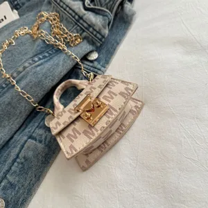 Detailed view of luxury mini monogram bag with elegant gold clasp and chain strap