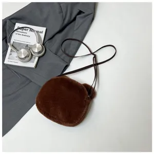 Close-up of brown plush bear-shaped crossbody bag with soft faux fur texture and slim strap.