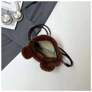 Close-up of the interior lining and zipper of a cute brown bear plush crossbody bag