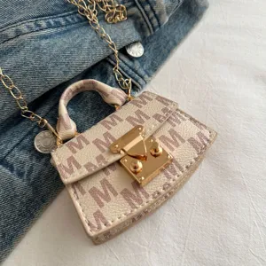 Elegant mini crossbody bag detail featuring luxury gold chain and M-pattern print texture