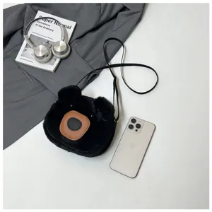 Close-up of a cute black bear plush crossbody bag on a white minimalist background