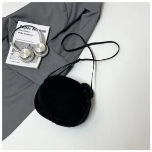 Detail view of the black plush bear-shaped bag showing soft texture and ears