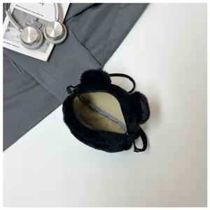 Top-down detailed view of the interior space of a cute black bear plush crossbody bag