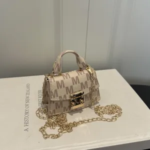 Elegant mini top handle bag with M-pattern and golden chain strap on a white catalog