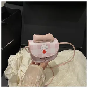 Vista detallada de un mini bolso a cuadros rosa con dibujo de perro animado y un lazo.